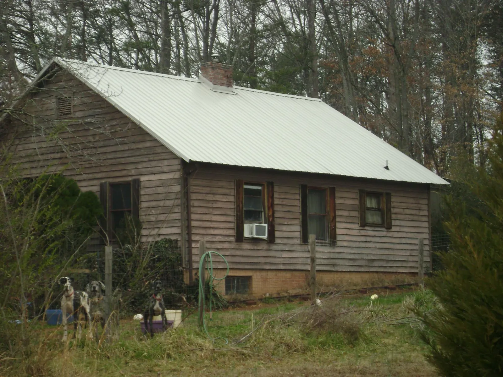 White metal roof on an old wood sided farmhouse, from a Metal Roof Installation job in Mokena